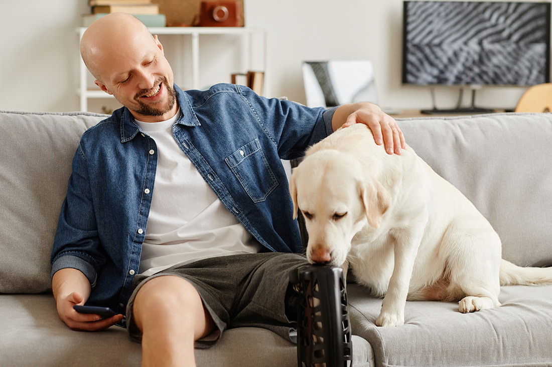 Man with prosthetic leg and his service dog
